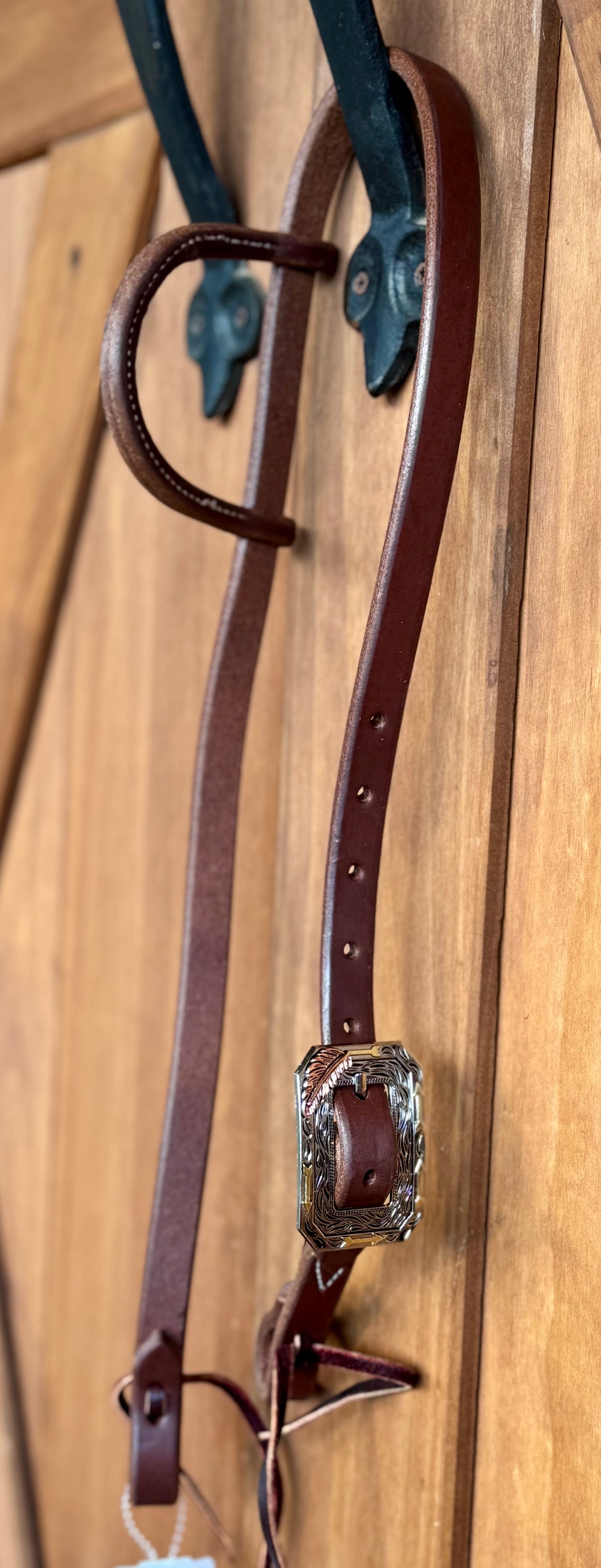 3/4” slip ear bridle with single copper feather and gold arrow buckle