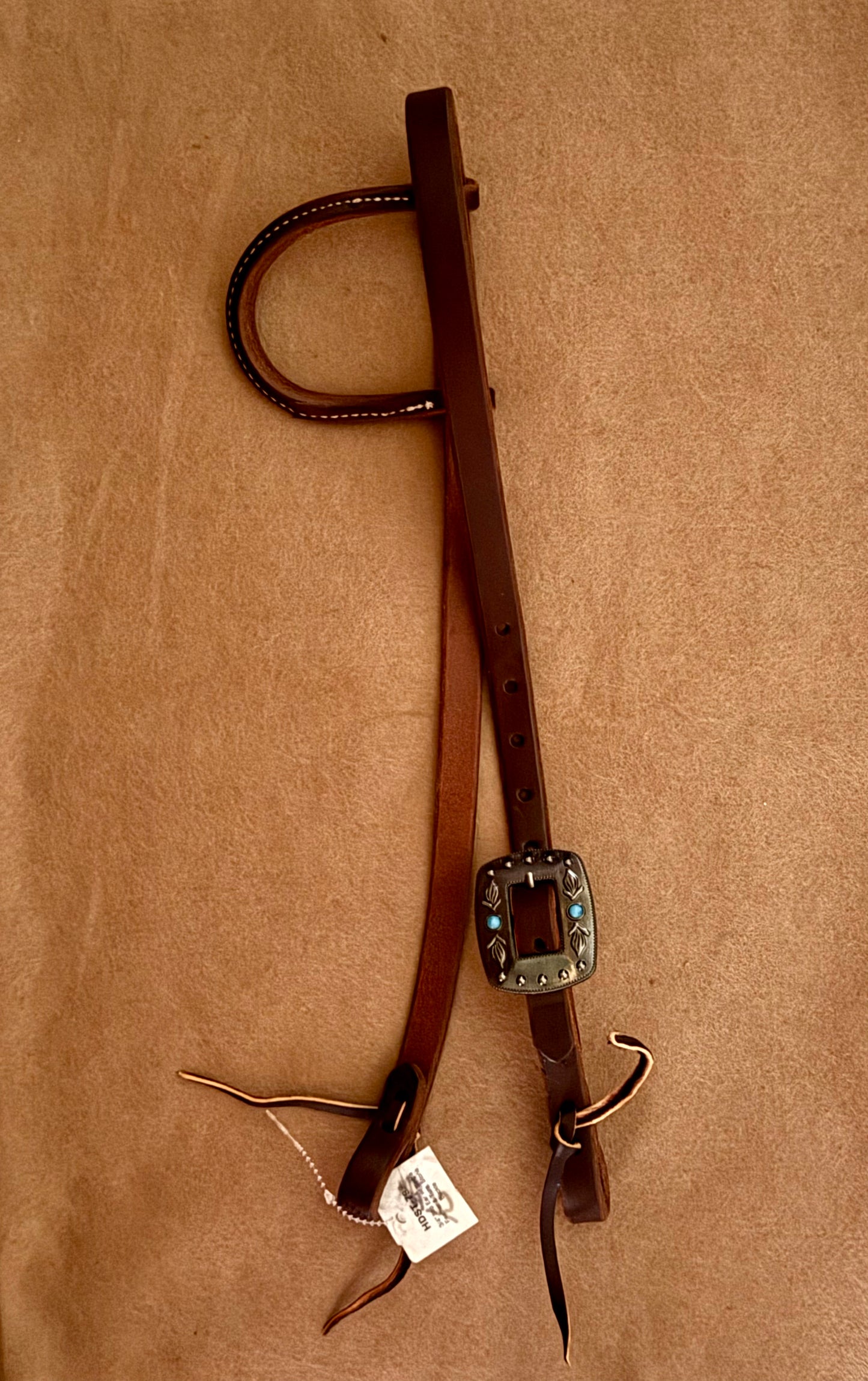 3/4” slip ear bridle. Single feather and turquoise stone buckle