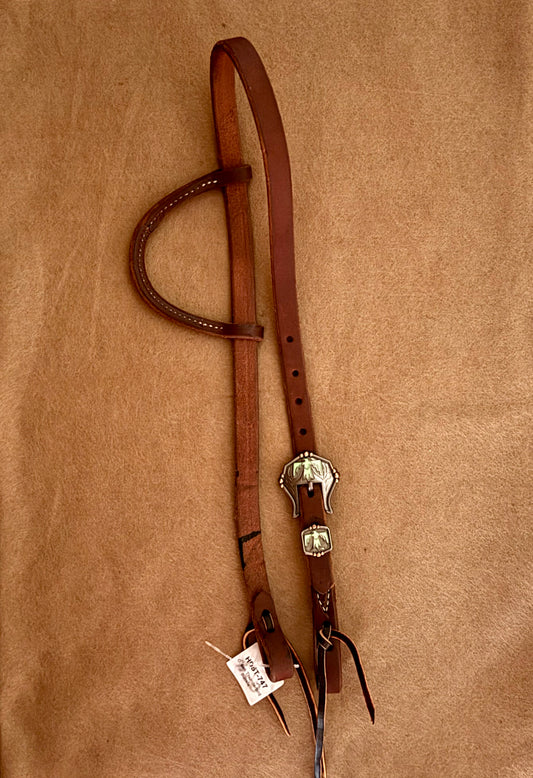 Slip ear bridle with green thunderbird buckle